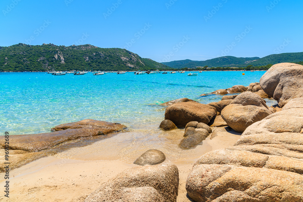 Rocks on sandy Santa Giulia beach with crystal clear azure sea water, Corsica island, France Rocks on sandy Santa Giulia beach with crystal clear azure sea water, Corsica island, France