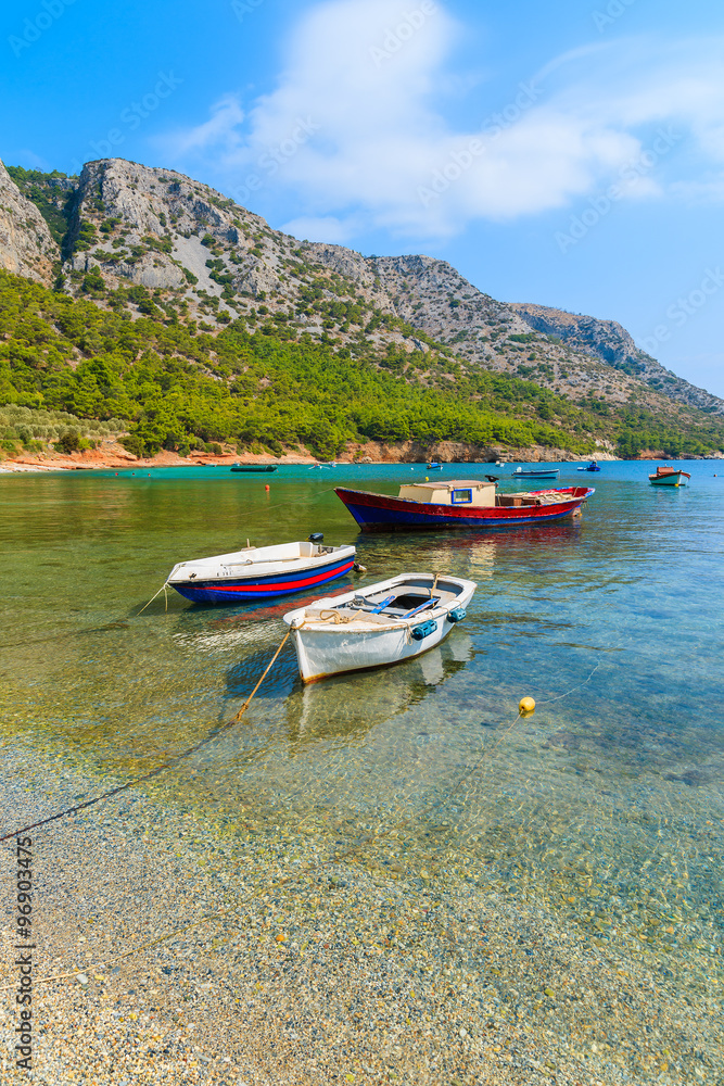 Traditional fishing boats in sea bay on secluded beach, Samos island, Greece