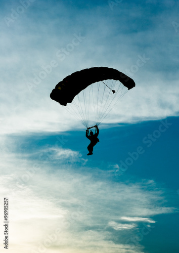 Parachutist silhouette contour on sky