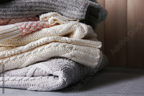 Warm clothes on wooden wall background