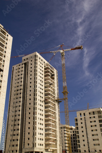 High-rise residential buildings under construction. The site with cranes