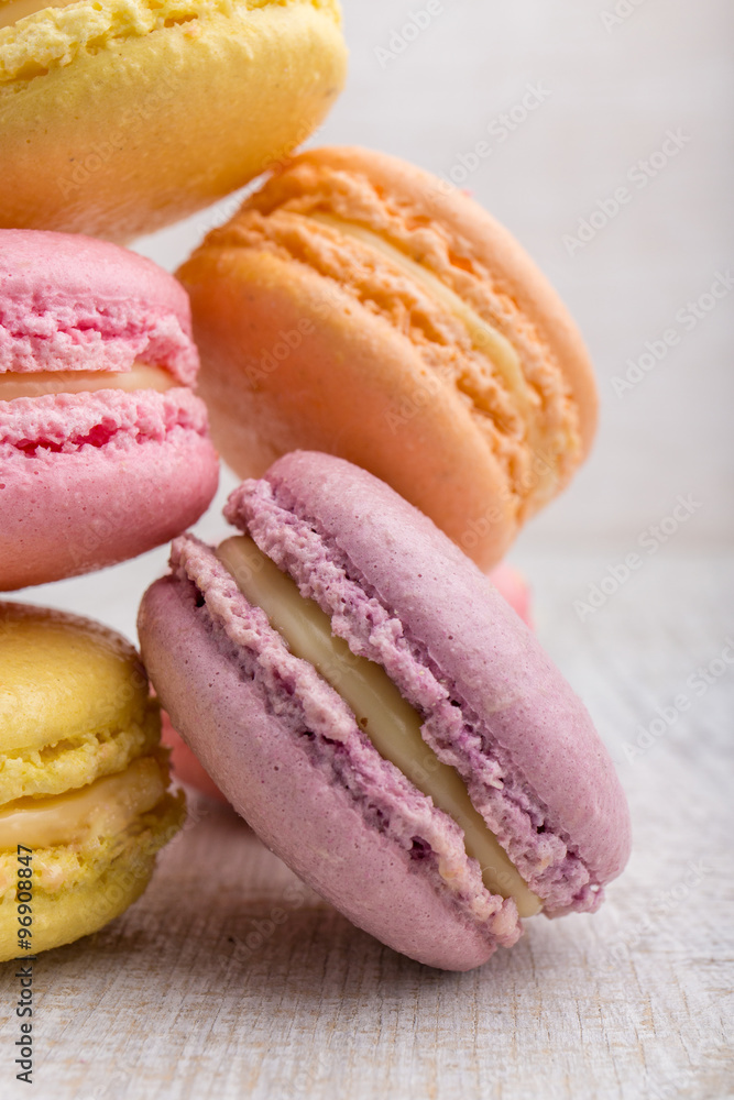 Colorful macarons on vintage pastel background