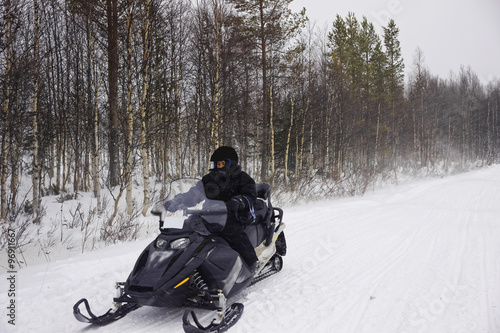 Man managing a snowmobile in Ruka of Lapland