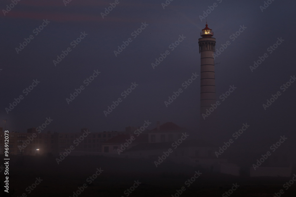 Lighthouse in a foggy dusk