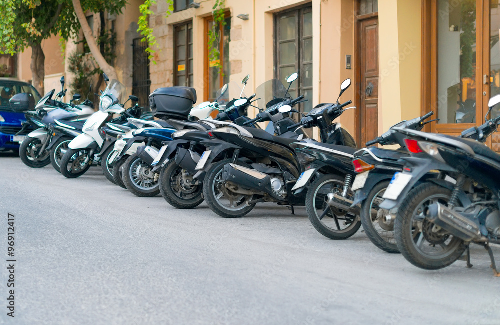 Row of motorcycles on the parking lot.
