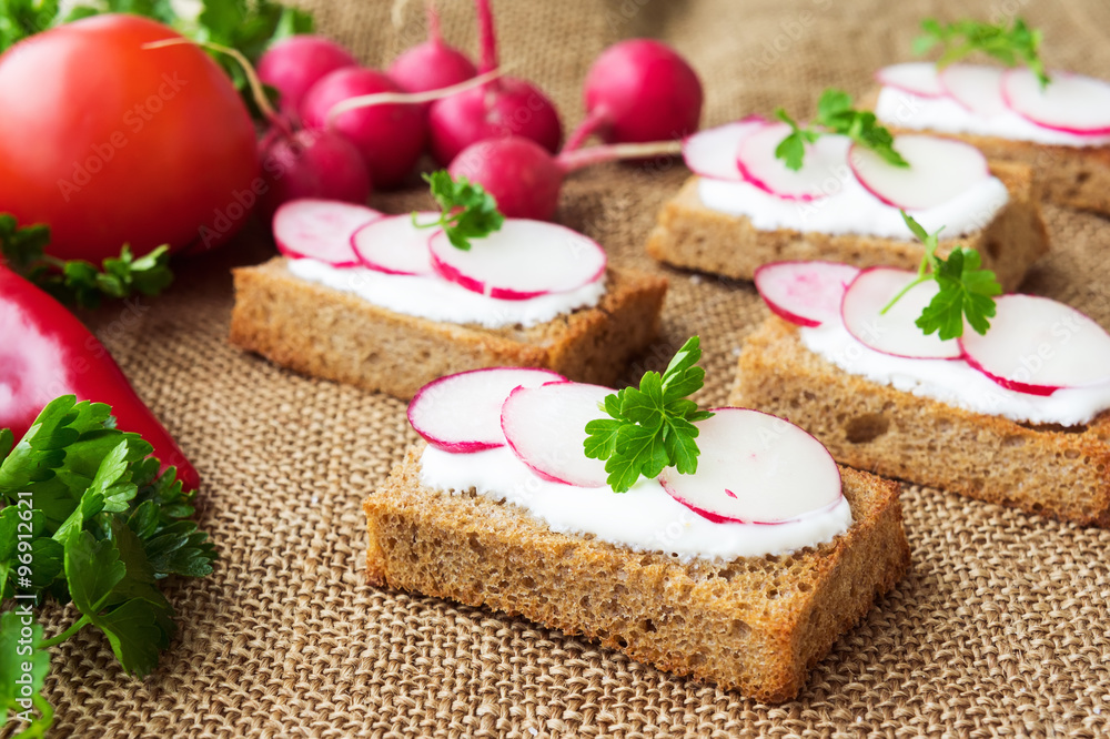 Sandwiches with soft cheese and radish, on sackcloth background Sandwiches with soft cheese and radish, on sackcloth background