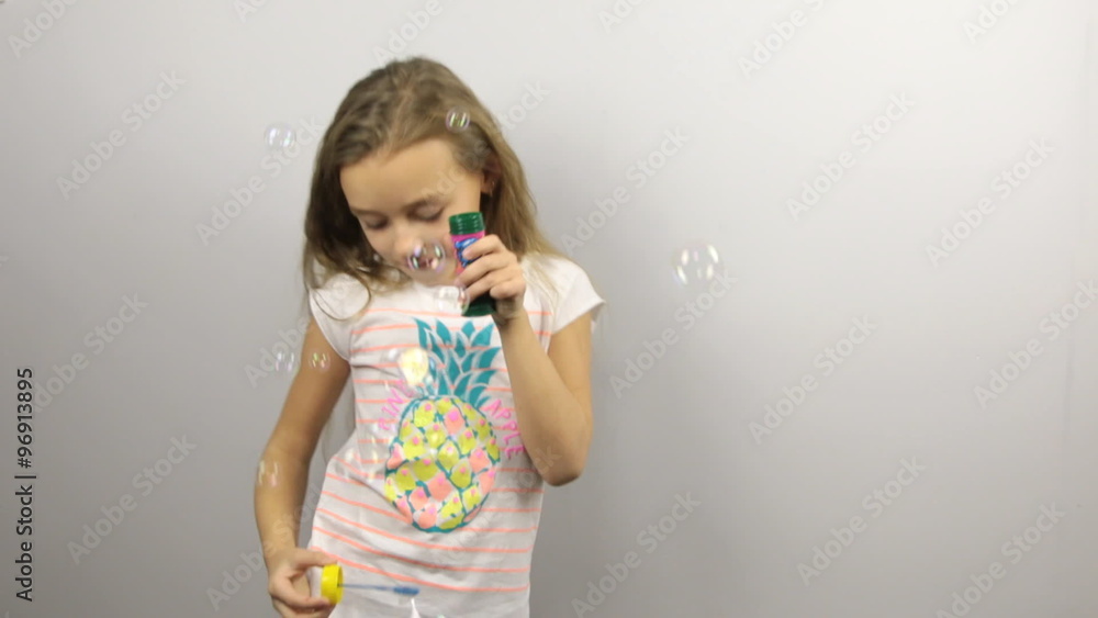 Young girl playing with soap bubbles Young girl playing with soap bubbles