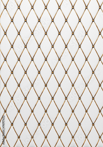 The white leather texture of the quilted skin with gold trim