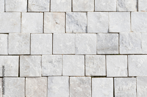 Top view of white granite cobblestone, full frame background, stone textured pattern