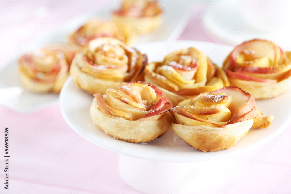 Fresh puff pastry with apple shaped roses on pink wooden table Fresh puff pastry with apple shaped roses on pink wooden table