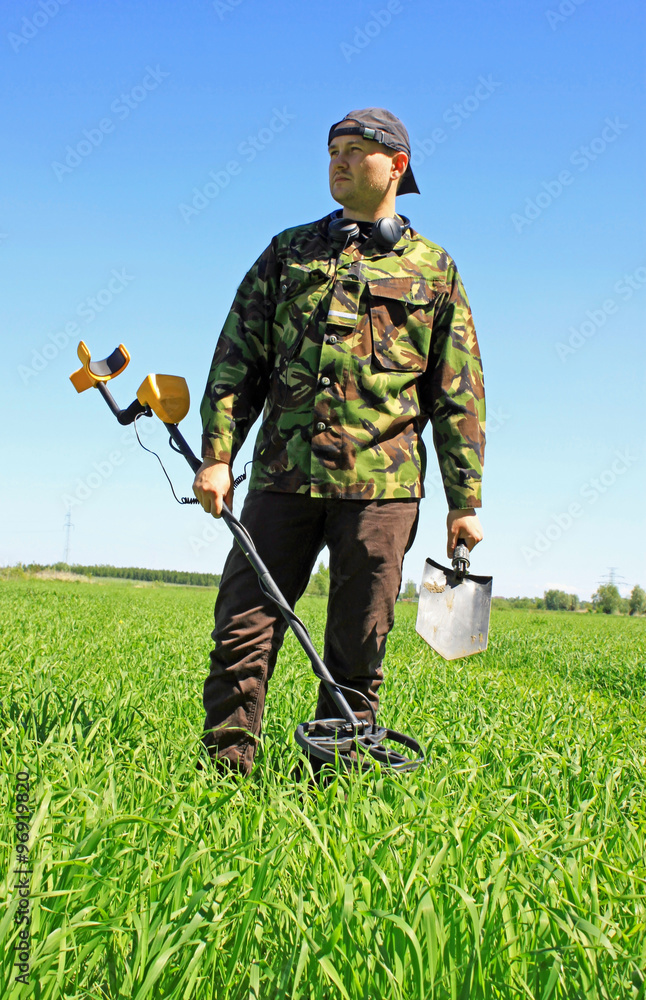 Man with metal detector on the battlefield of WW2 Man with metal detector on the battlefield of WW2