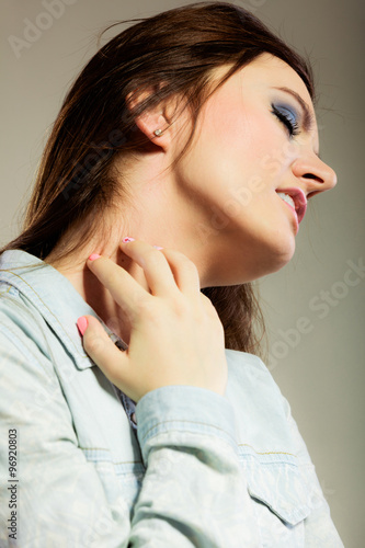 Woman scratching her neck