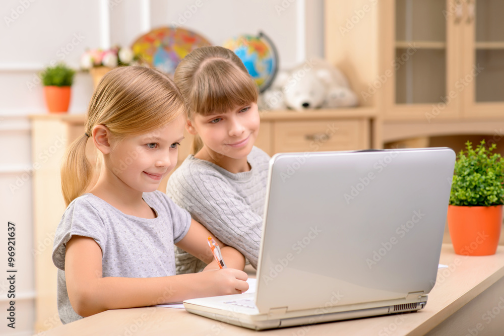 Pretty little girls sitting at the table Pretty little girls sitting at the table
