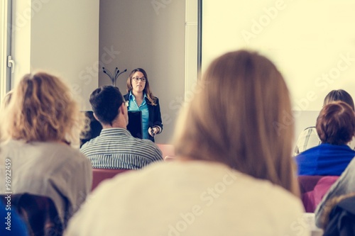 Business woman delivering a speach.