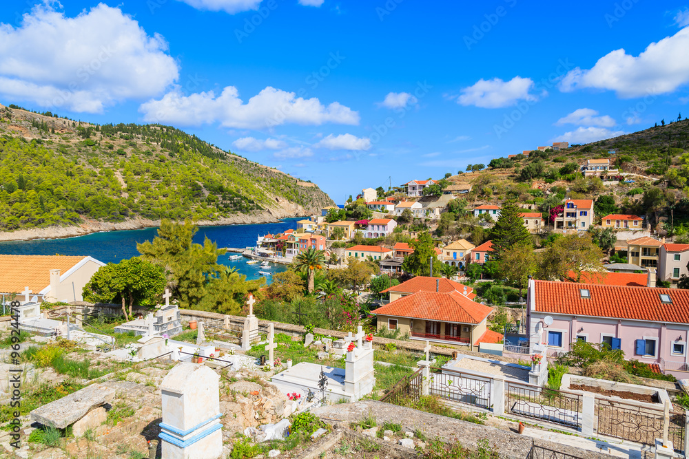 Colorful houses built on green hills in Assos village on Kefalonia island, Greece