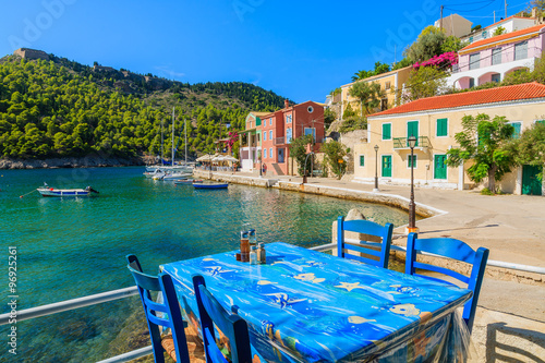 Table in Greek tavern on coast of Kefalonia island in Assos fishing village, Greece