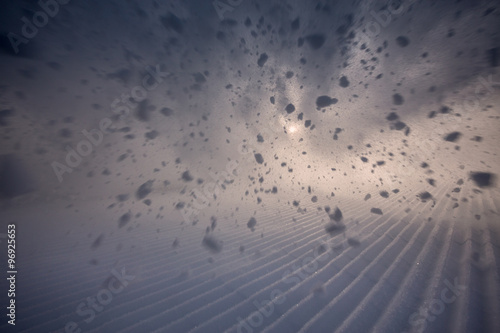 Leinwand Poster snow spraying on skiing piste