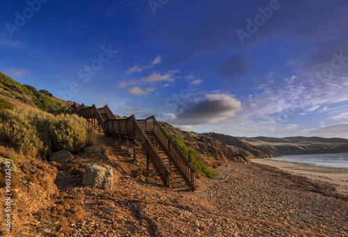 Scenic coastline landscape at sunset with cliff boulders on the