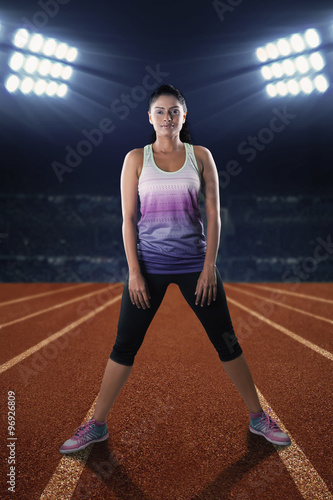 Fitness woman standing on the track