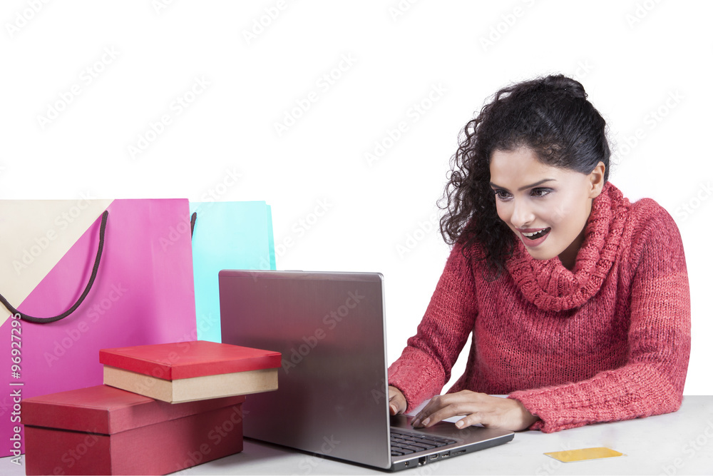 Indian woman with winter clothes shopping online Indian woman with winter clothes shopping online