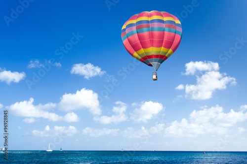 Colorful hot air balloon over blue sea