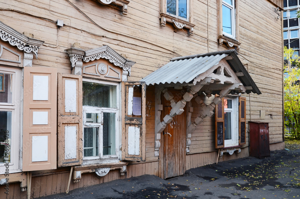 Two-storey wooden house with porch and window shutters on Irkutsk street