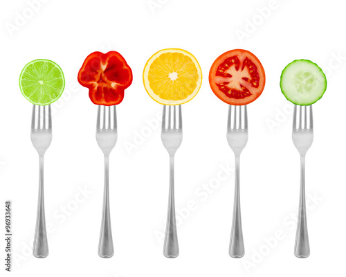 Healthy diet, organic food on forks with vegetables and fruit.