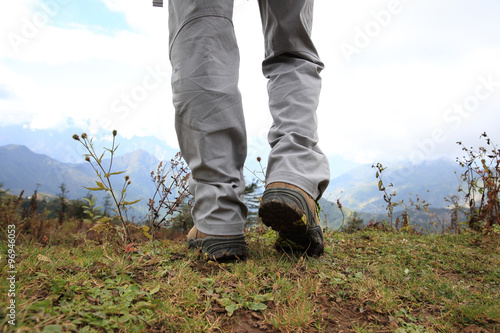 hiking legs on mountain peak