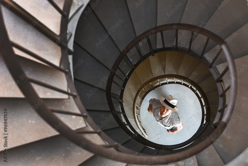 spiral staircase with a man below