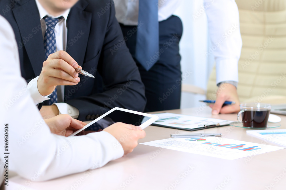 Business colleagues working and analyzing financial figures on a Business colleagues working and analyzing financial figures on a