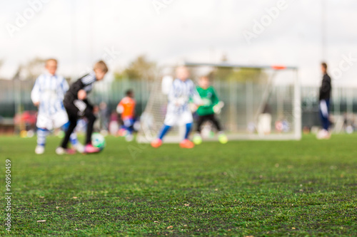 Blurred young kids playing soccer