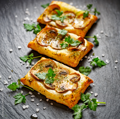 Mini tarts with puff pastry with the addition of mushrooms