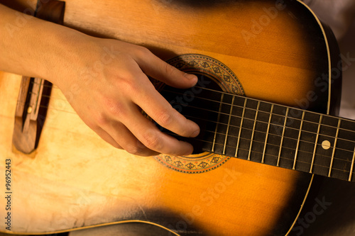 Quadro em tela Young guy playing on guitar