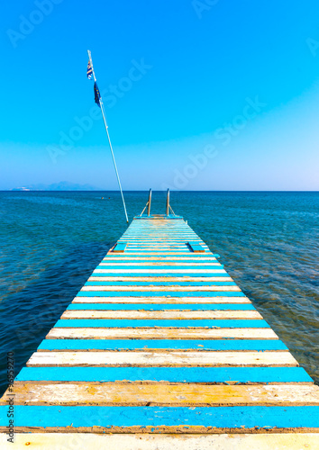 Beautiful wooden pier at a beach in kefalos area in Kos island in Greece photo