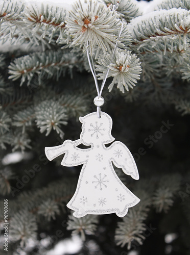 Christmas white angel with silvery snowflakes on christmas tree