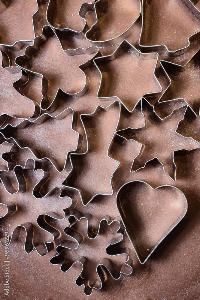 Gingerbread dough and Christmas cookie cutters Gingerbread dough and Christmas cookie cutters