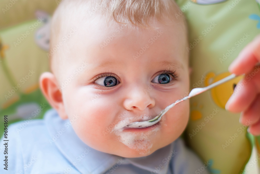 Baby with blue eyes looking at camera, indoors Baby with blue eyes looking at camera, indoors