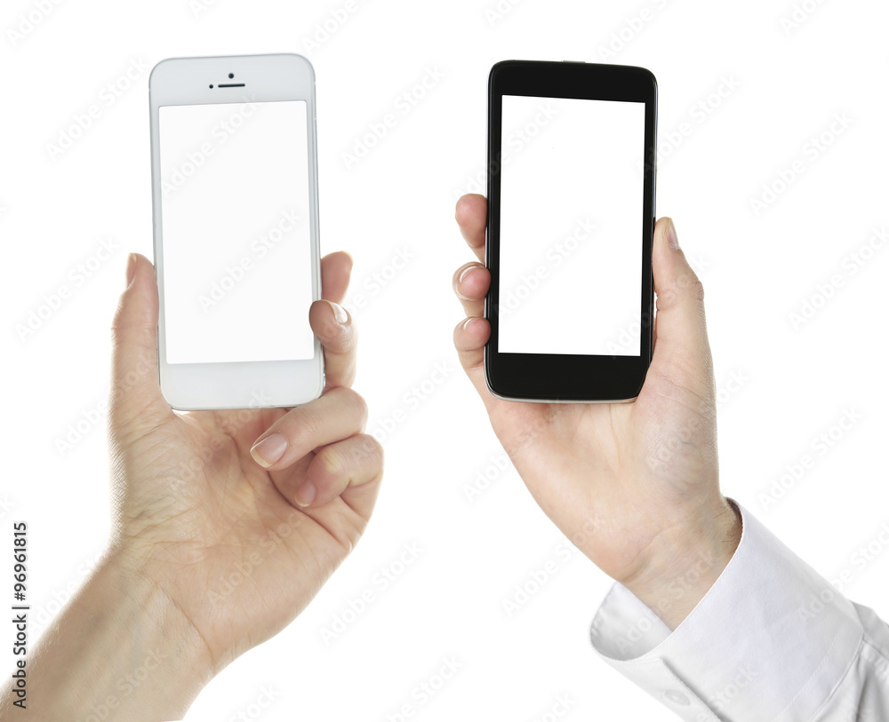 Hands holding black and white smart phones, isolated on white Hands holding black and white smart phones, isolated on white