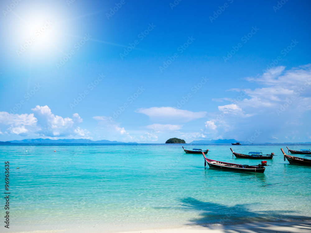 Beach and boats with sun light ray background