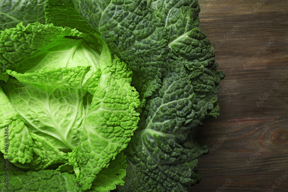 Savoy cabbage on wooden background, close up Savoy cabbage on wooden background, close up