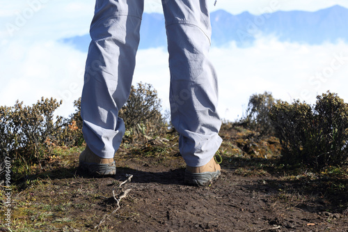 hiker legs stand on mountain peak