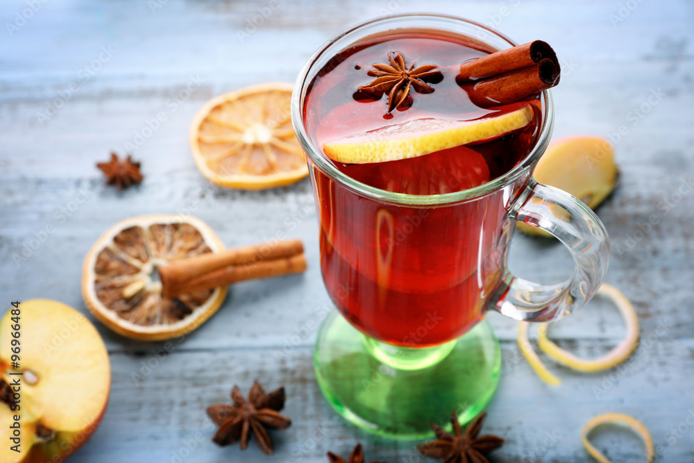 Tasty mulled wine and spices, on blue wooden background, close-up Tasty mulled wine and spices, on blue wooden background, close-up