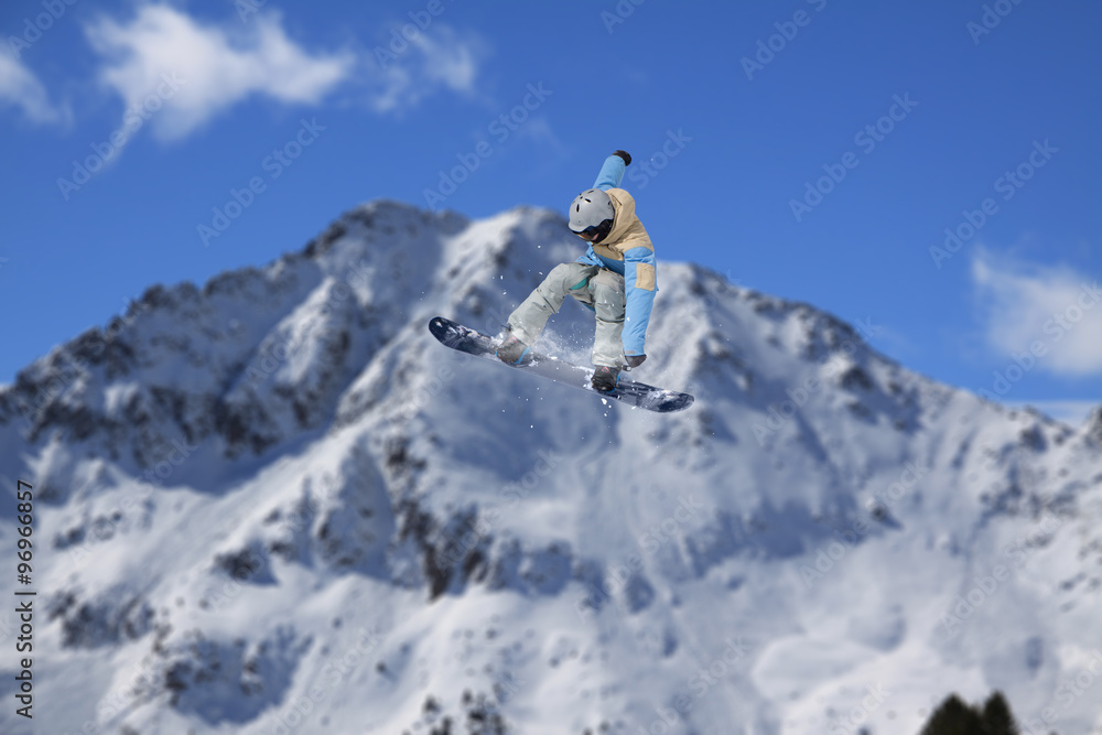 Flying snowboarder on mountains. Extreme sport.