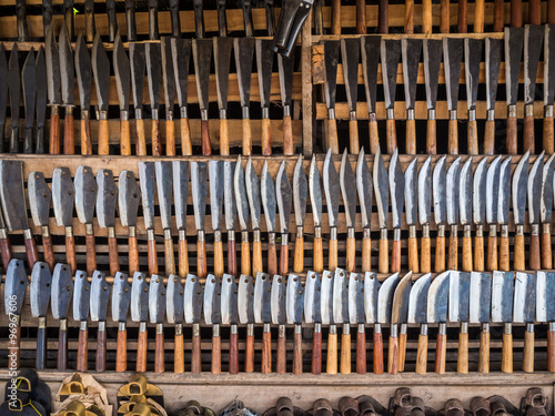 Many kind of knifes on wooden shelf