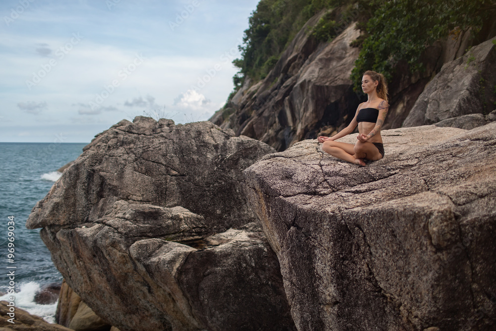 meditation.photo of the girl who is sitting in the lotus position on the rocks at the water meditation.photo of the girl who is sitting in the lotus position on the rocks at the water
