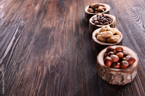 Assortment of tasty nuts on wooden background