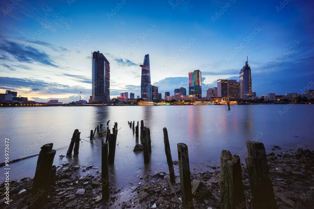 Fototapeta premium Downtown Saigon in twilight (view from Thu Thiem district) (HDR), Ho Chi Minh city, Vietnam. Saigon is the largest city and economic center in Vietnam with population around 10 million people.