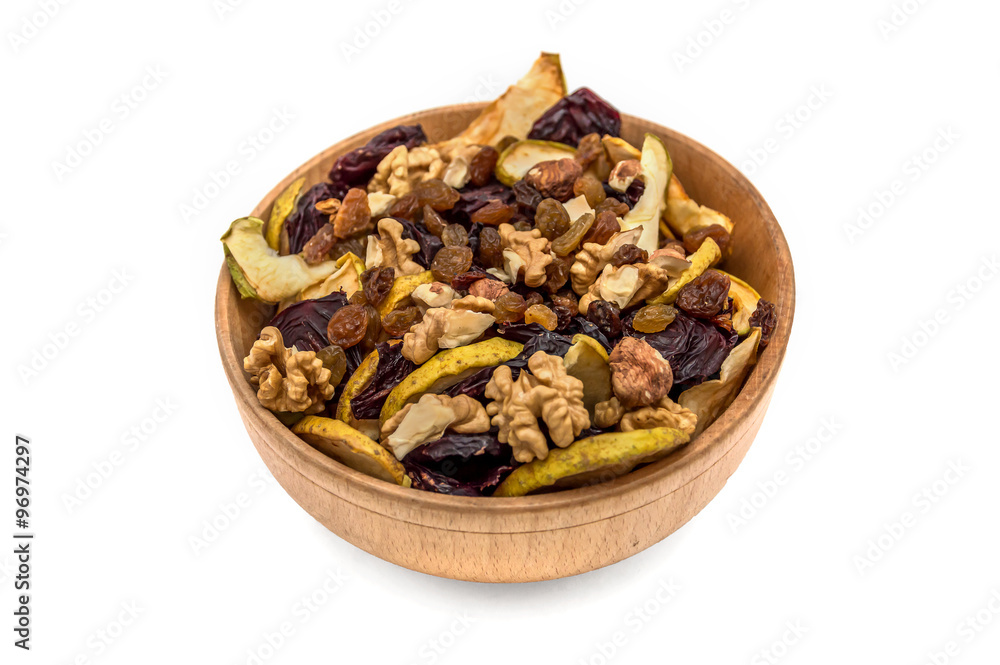 Wooden bowl with dried fruits and nuts isolated on white backgro Wooden bowl with dried fruits and nuts isolated on white backgro