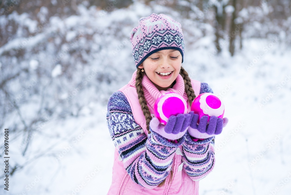 beautiful little girl holding a Christmas ball for Christmas tree decoration Smiley girl holding 2 pink decorative balls. Before Christmas, girl walking in winter forest
beautiful little girl holding a Christmas ball for Christmas tree decoration Smiley girl holding 2 pink decorative balls. Before Christmas, girl walking in winter forest