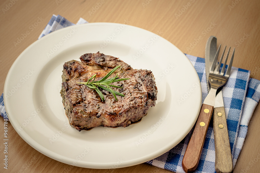 Juicy grilled rib eye steak with cutlery